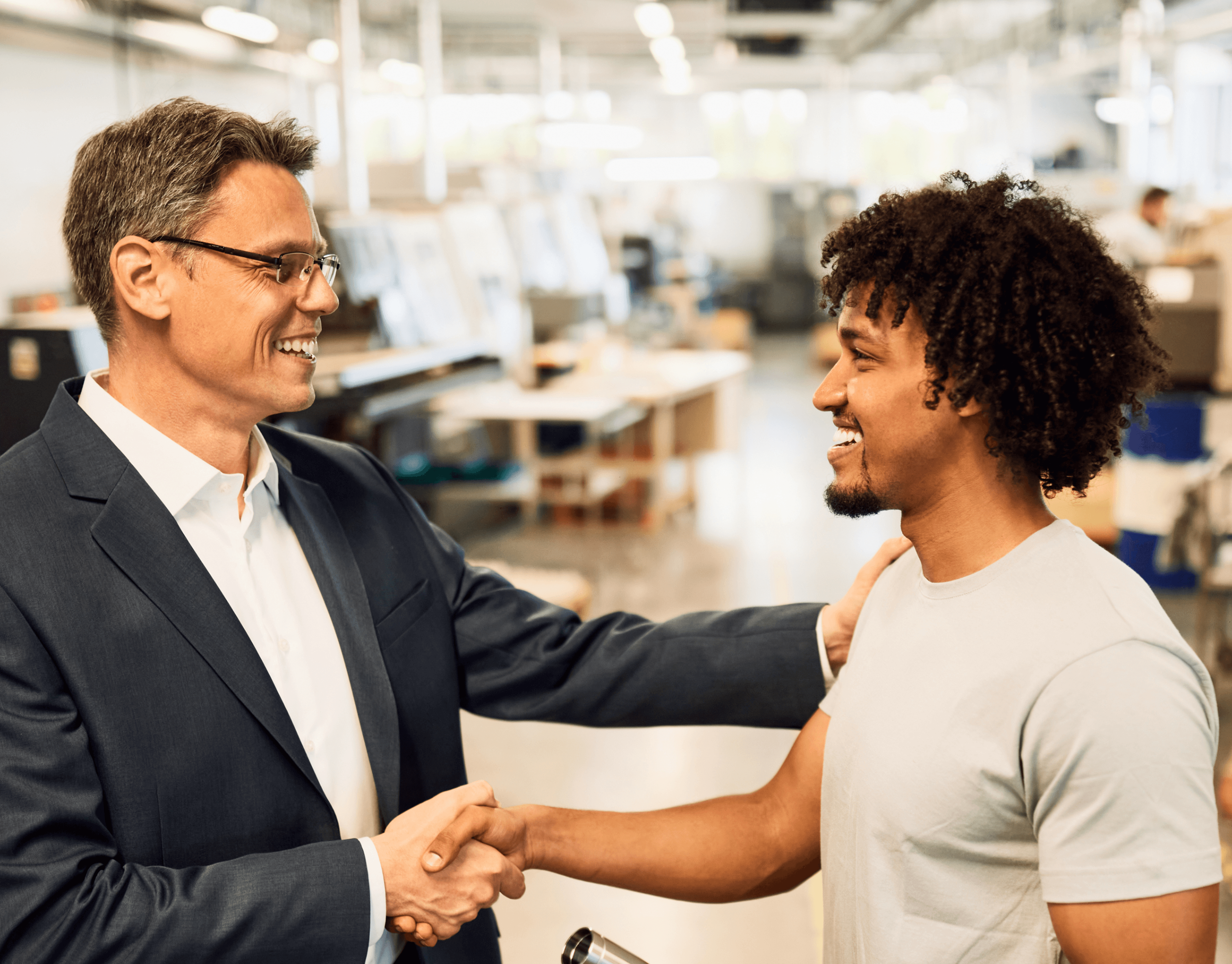 Manager shaing hands with employee.