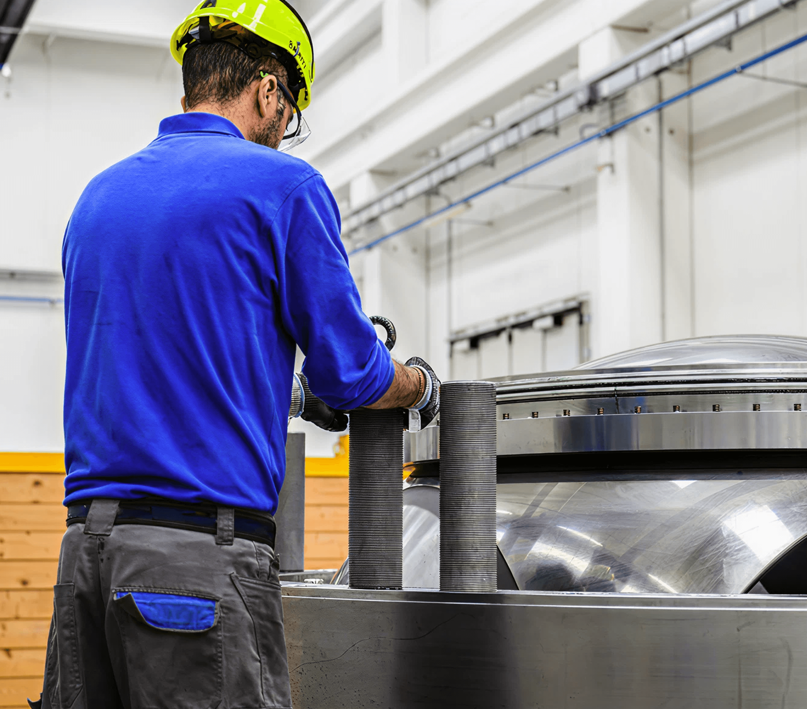 Man wearing safety helmet working in a factory.